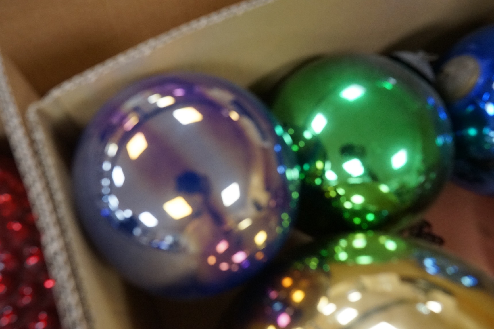 A collection of coloured circular and grape shaped glass witches balls and decorations, largest grape decoration 40cm in length